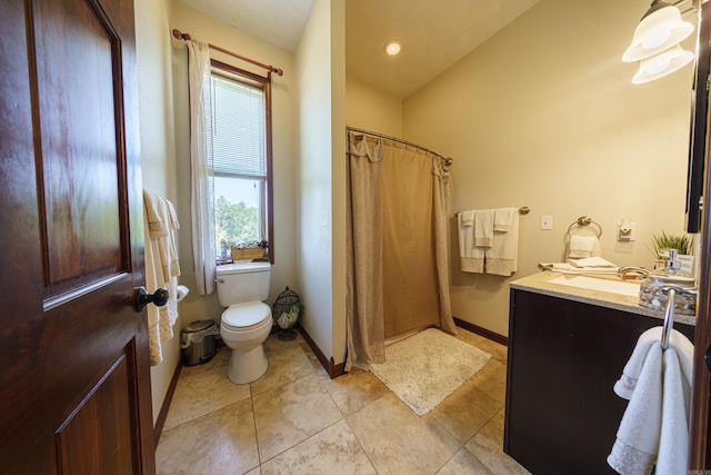 bathroom featuring lofted ceiling, toilet, and vanity