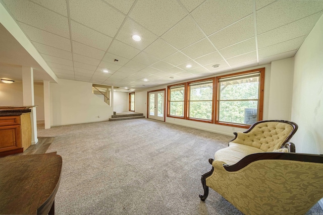 sitting room with light carpet and a drop ceiling