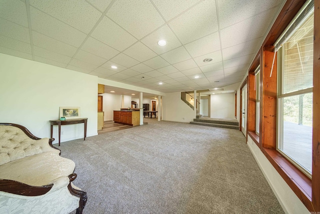 unfurnished room featuring a paneled ceiling and carpet flooring