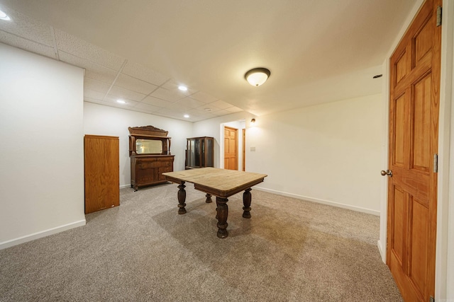 playroom featuring light colored carpet and a paneled ceiling