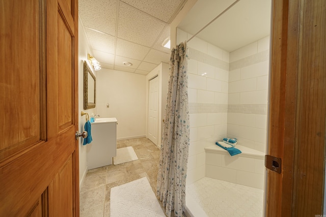 bathroom featuring vanity, a shower with curtain, and a paneled ceiling