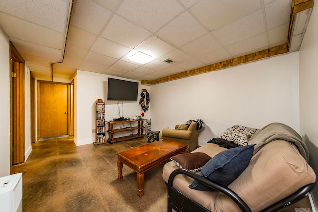 interior space with a paneled ceiling