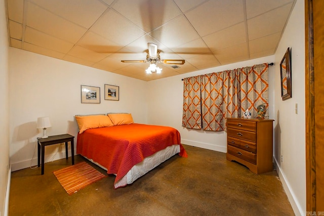 bedroom with concrete floors, a paneled ceiling, and ceiling fan