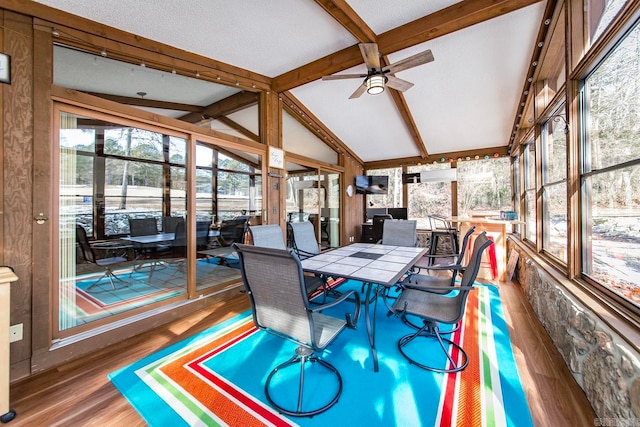 sunroom / solarium featuring ceiling fan and vaulted ceiling with beams