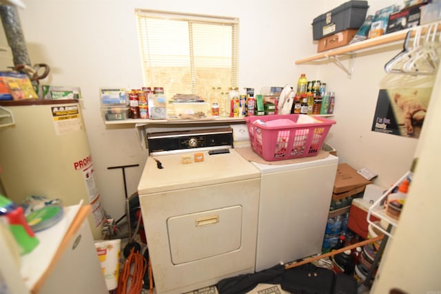 clothes washing area with water heater and washer and dryer