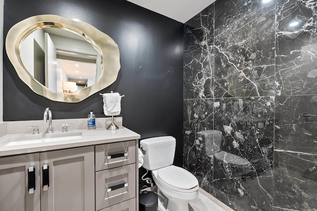 bathroom featuring vanity, toilet, and a shower