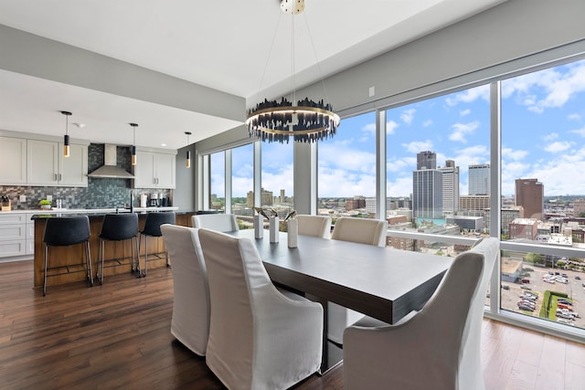 dining room featuring dark hardwood / wood-style floors and an inviting chandelier