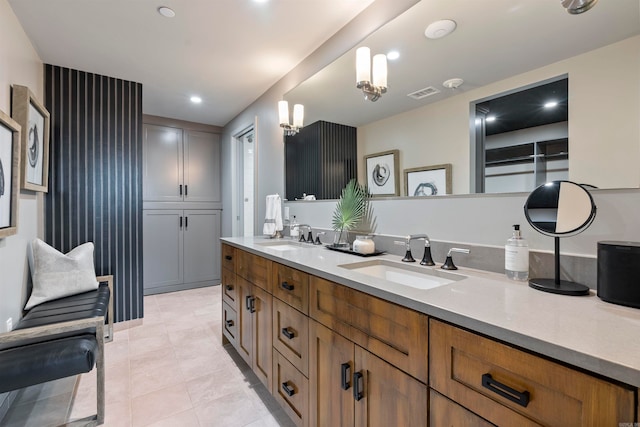 bathroom with vanity, a chandelier, and tile patterned flooring