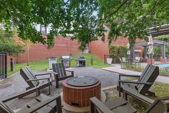 view of patio featuring a pergola, grilling area, and an outdoor fire pit