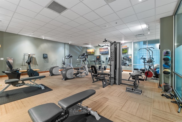 exercise room featuring light colored carpet and a drop ceiling