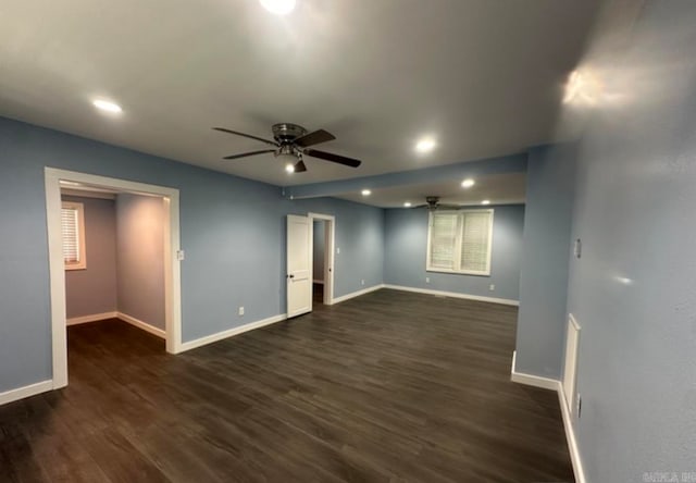 spare room with dark wood-type flooring and ceiling fan