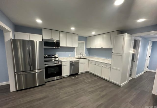 kitchen featuring white cabinets, dark hardwood / wood-style flooring, stainless steel appliances, and sink