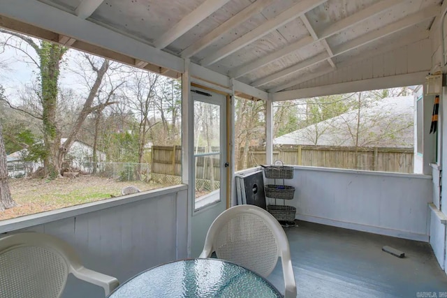 sunroom / solarium featuring vaulted ceiling