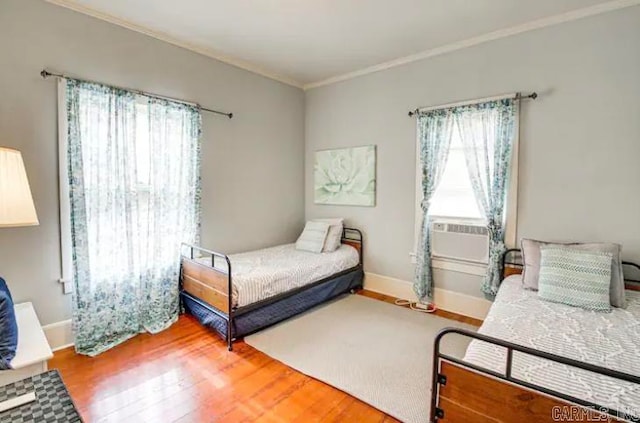 bedroom with crown molding and hardwood / wood-style floors