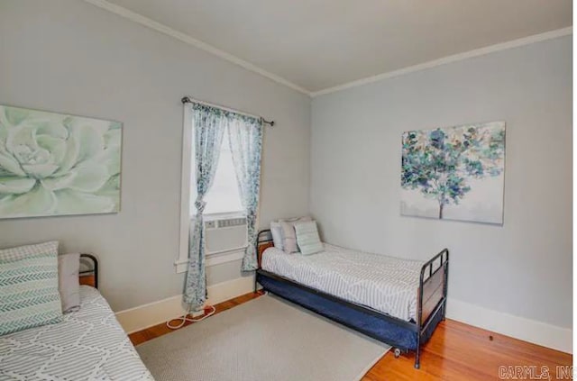 bedroom featuring crown molding and hardwood / wood-style floors