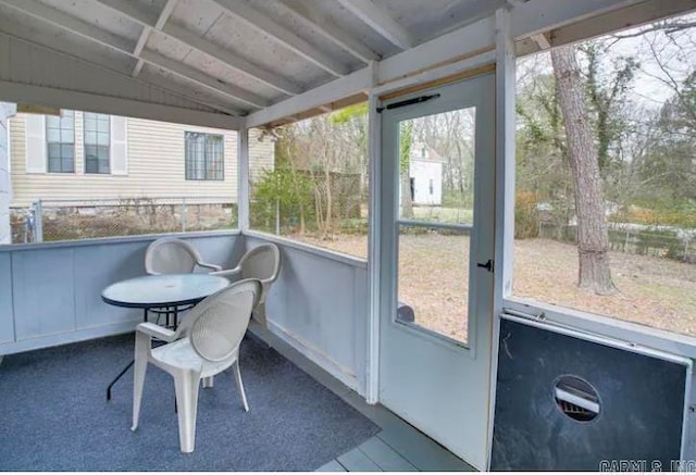 sunroom / solarium featuring vaulted ceiling