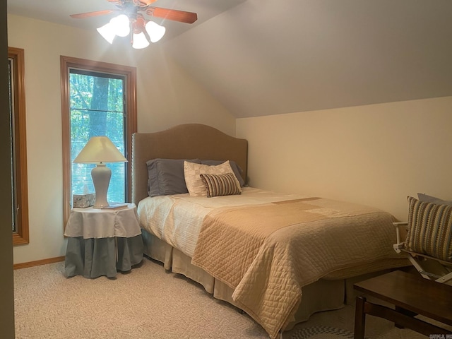 bedroom with vaulted ceiling, ceiling fan, and carpet