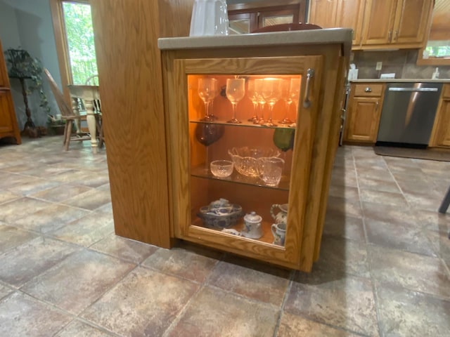 details featuring dishwasher and tasteful backsplash