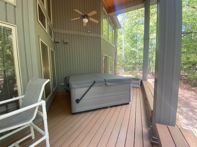 deck featuring ceiling fan and a covered hot tub