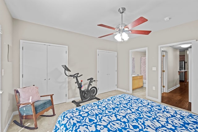 bedroom with a closet, ceiling fan, ensuite bath, and hardwood / wood-style flooring