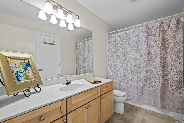 bathroom with vanity, toilet, a shower with shower curtain, and tile patterned floors