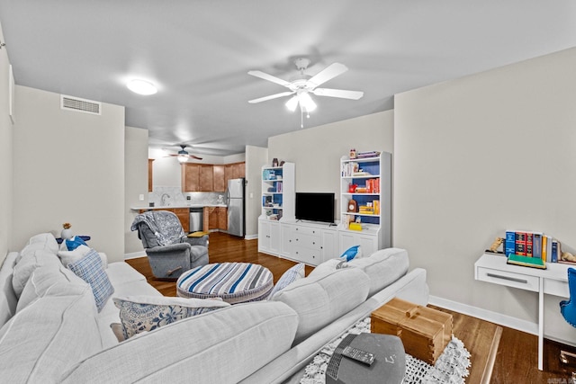 living room with wood-type flooring, sink, and ceiling fan