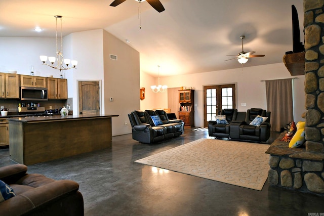 living room with ceiling fan with notable chandelier, a fireplace, and high vaulted ceiling