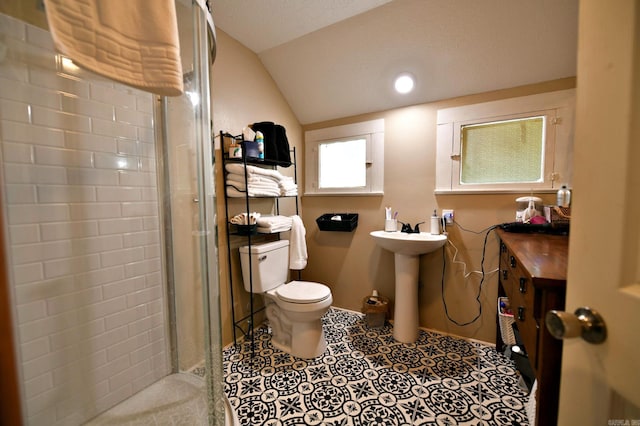 bathroom with toilet, tile patterned flooring, sink, lofted ceiling, and a shower with shower door