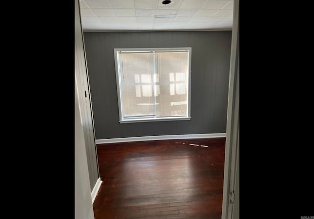 unfurnished room featuring dark hardwood / wood-style floors