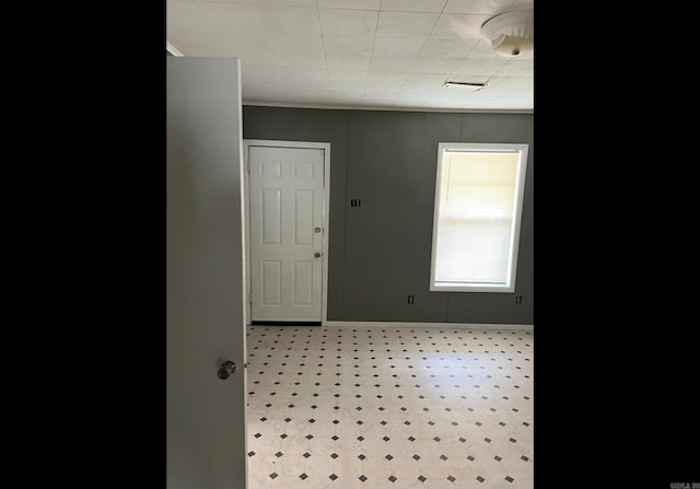 spare room with crown molding