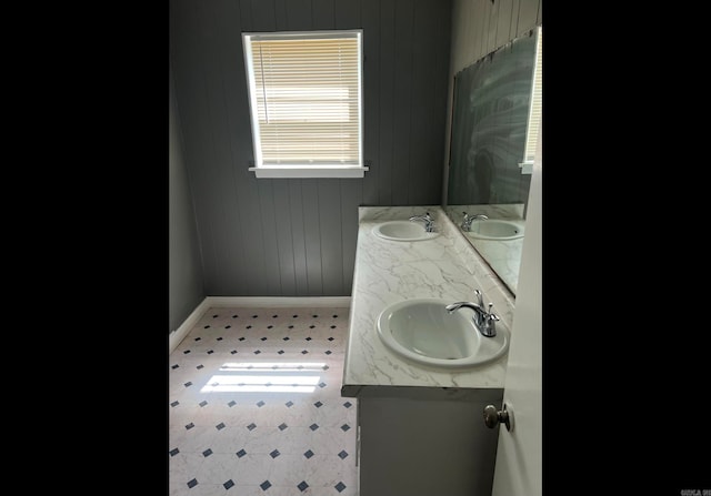 bathroom with wood walls and vanity