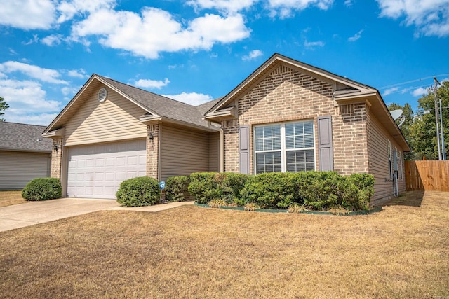 view of front of home featuring a garage and a front yard