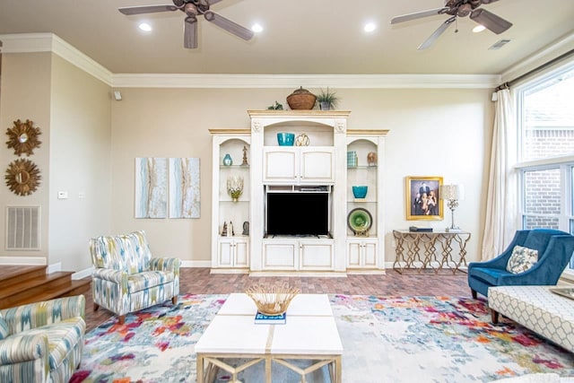 living room featuring ornamental molding, hardwood / wood-style floors, and ceiling fan