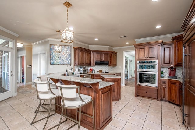 kitchen with pendant lighting, stainless steel double oven, decorative backsplash, and a chandelier