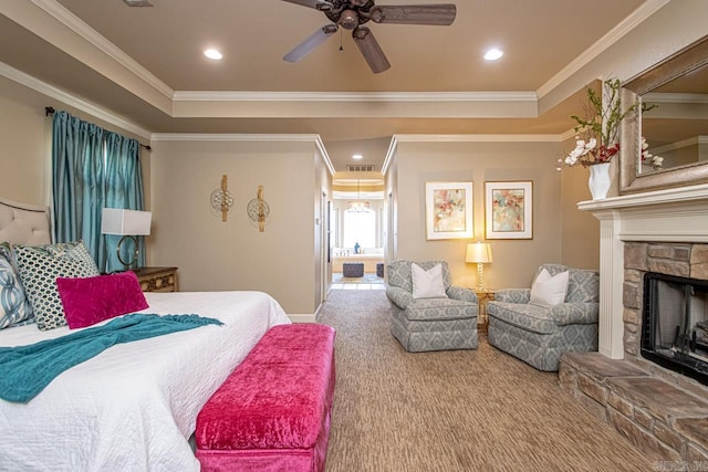 bedroom with crown molding, ceiling fan, carpet, and a fireplace