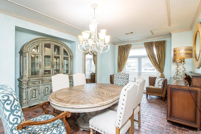 dining space featuring crown molding and a chandelier