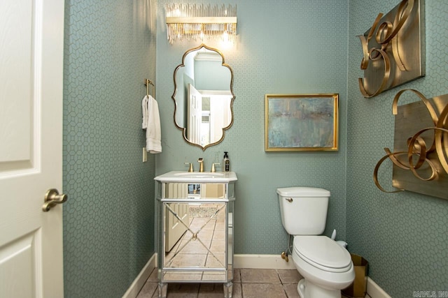 bathroom featuring toilet, sink, and tile patterned floors