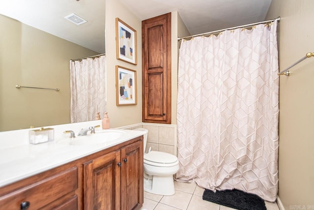 bathroom with vanity, toilet, and tile patterned flooring