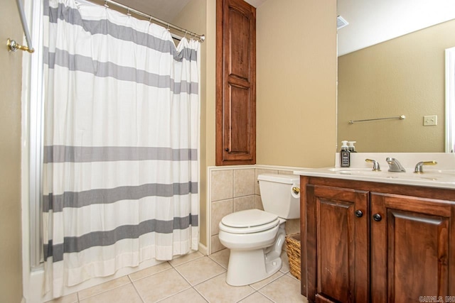 bathroom featuring tile patterned floors, toilet, curtained shower, and vanity