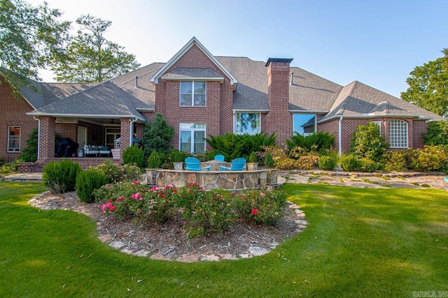 rear view of house featuring a yard