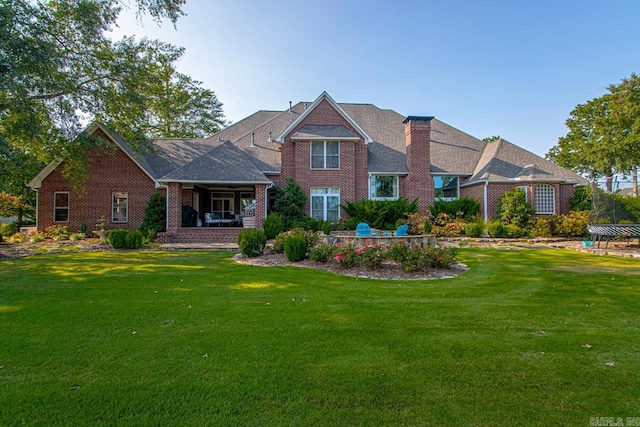 rear view of property with a lawn