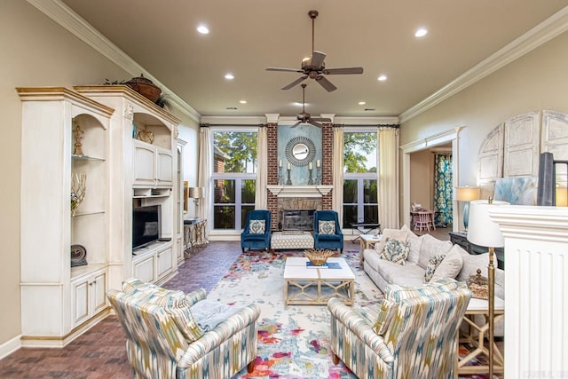 living room with a fireplace, ornamental molding, and ceiling fan