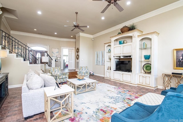 living room with ceiling fan and ornamental molding