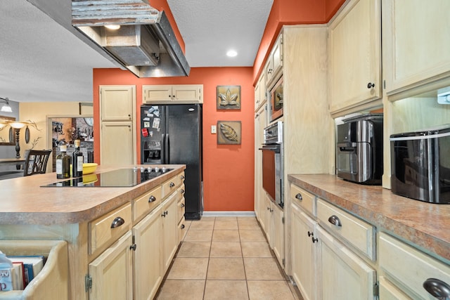 kitchen with a textured ceiling, black appliances, light tile patterned floors, and a kitchen island