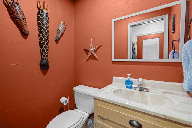 bathroom featuring toilet and vanity