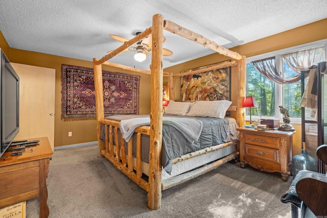 carpeted bedroom with a textured ceiling and ceiling fan