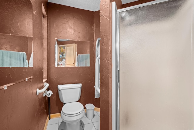 bathroom with toilet, a shower with door, a textured ceiling, and tile patterned floors