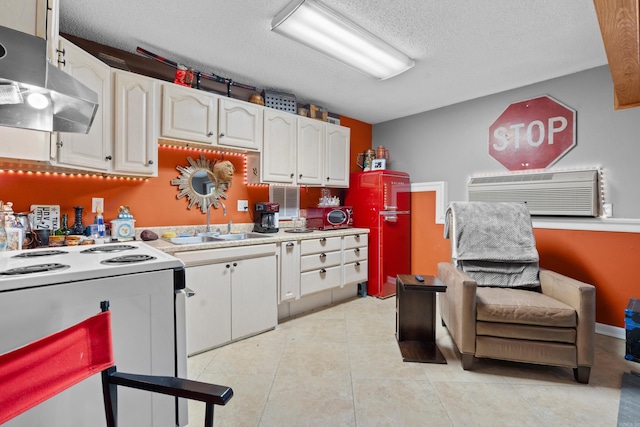 kitchen featuring ventilation hood, sink, white electric range, light tile patterned flooring, and an AC wall unit