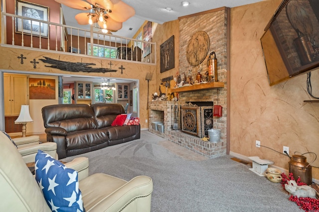 carpeted living room with a fireplace, a textured ceiling, high vaulted ceiling, and ceiling fan