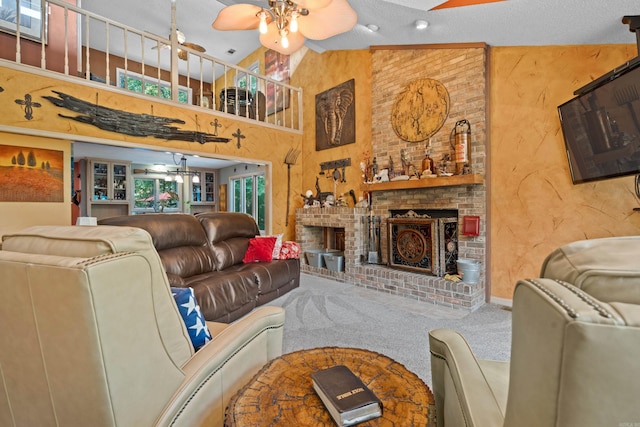 carpeted living room with a textured ceiling, high vaulted ceiling, ceiling fan, and a brick fireplace